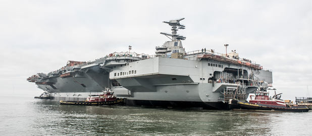 Nov. 17, 2013 - Gerald R. Ford (CVN 78) takes its first journey, leaving the dry dock at Newport News Shipbuilding where it was constructed and moving a mile downriver to complete final outfitting and testing. Photo by Chris Oxley / NNS
